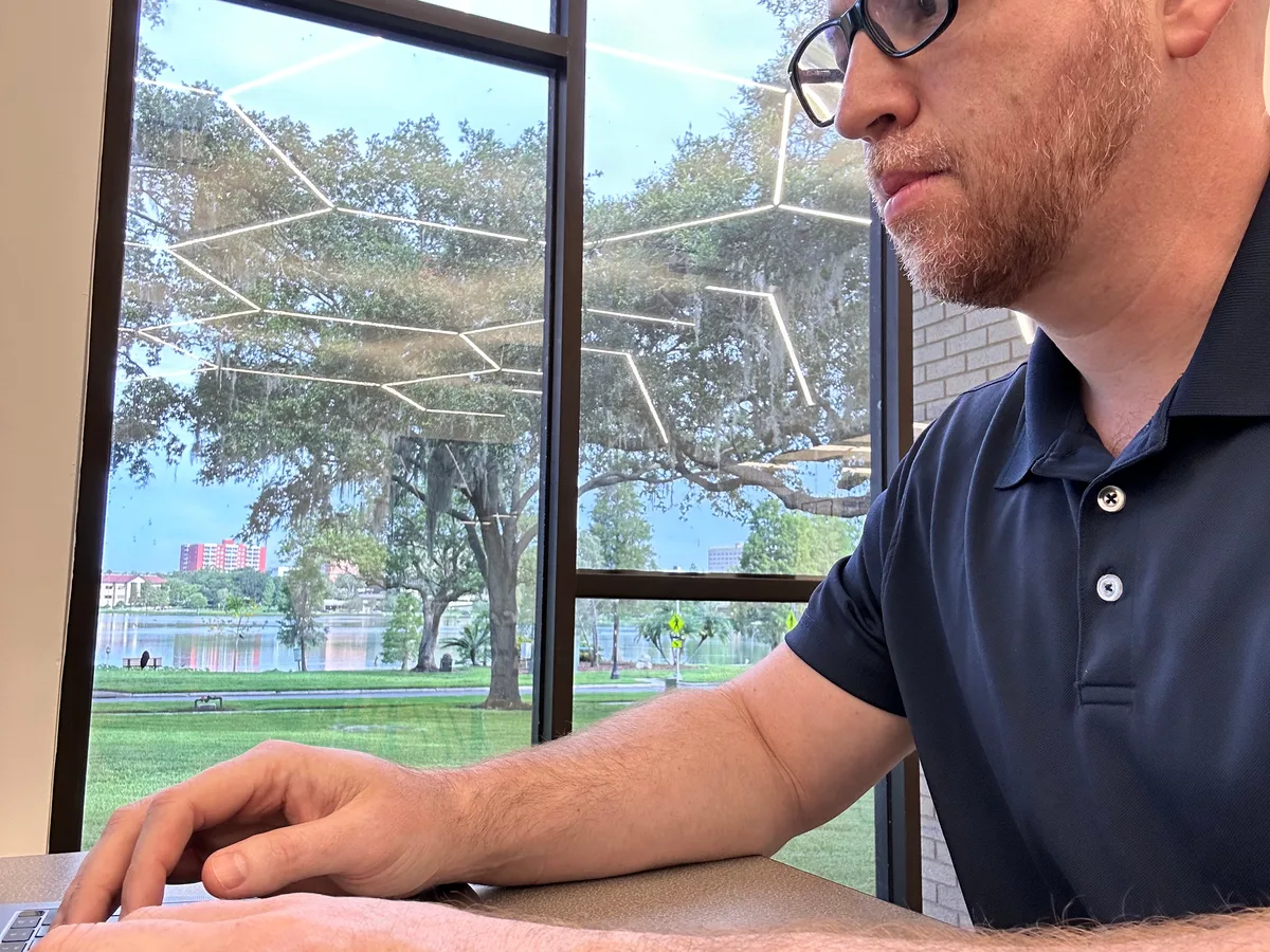Chadwick Bearden, owner of VetBuysHomes, working in Lakeland, Florida with the lakefront in the background